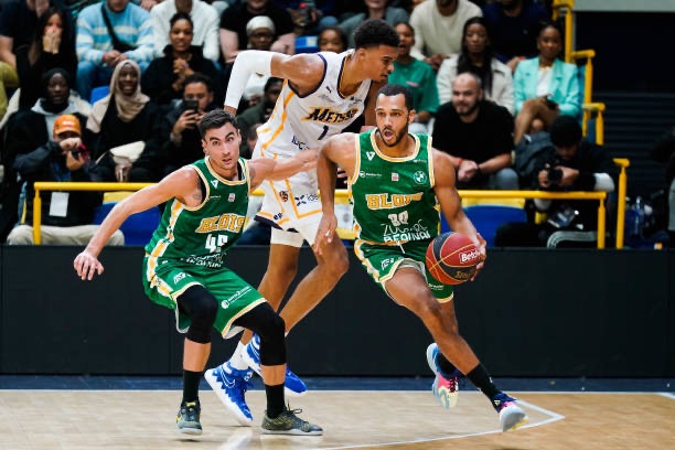 Paul Rigot with the ball against Victor Wembanyama during a professional game